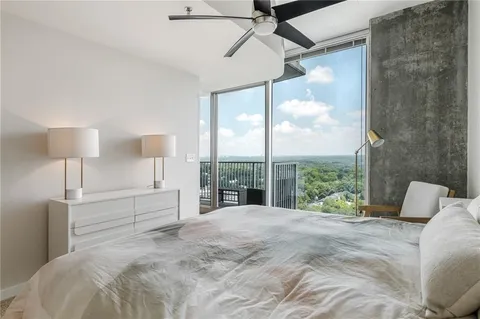 a living room with furniture and a floor to ceiling window