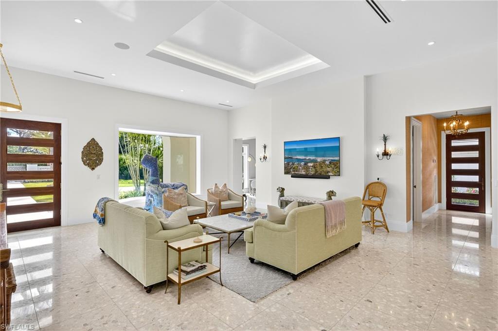 111 Caribbean Road Naples, FL 34108 - Photo 11 of 50 a living room with furniture and a window