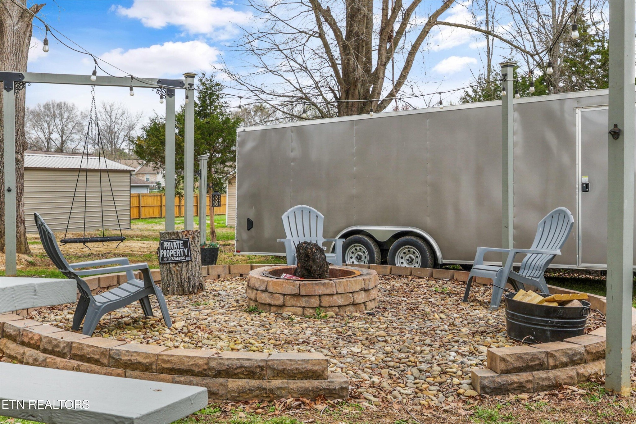 1306 Tabitha Drive White Pine, TN 37890 - Photo 18 of 31 a backyard of a house with table chairs and outdoor kitchen