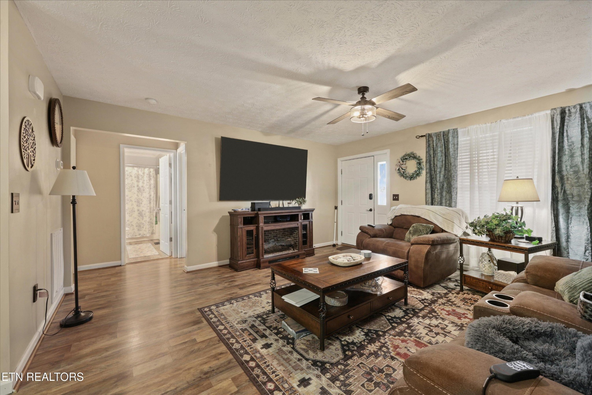 1306 Tabitha Drive White Pine, TN 37890 - Photo 7 of 31 a living room with furniture a rug and a flat screen tv