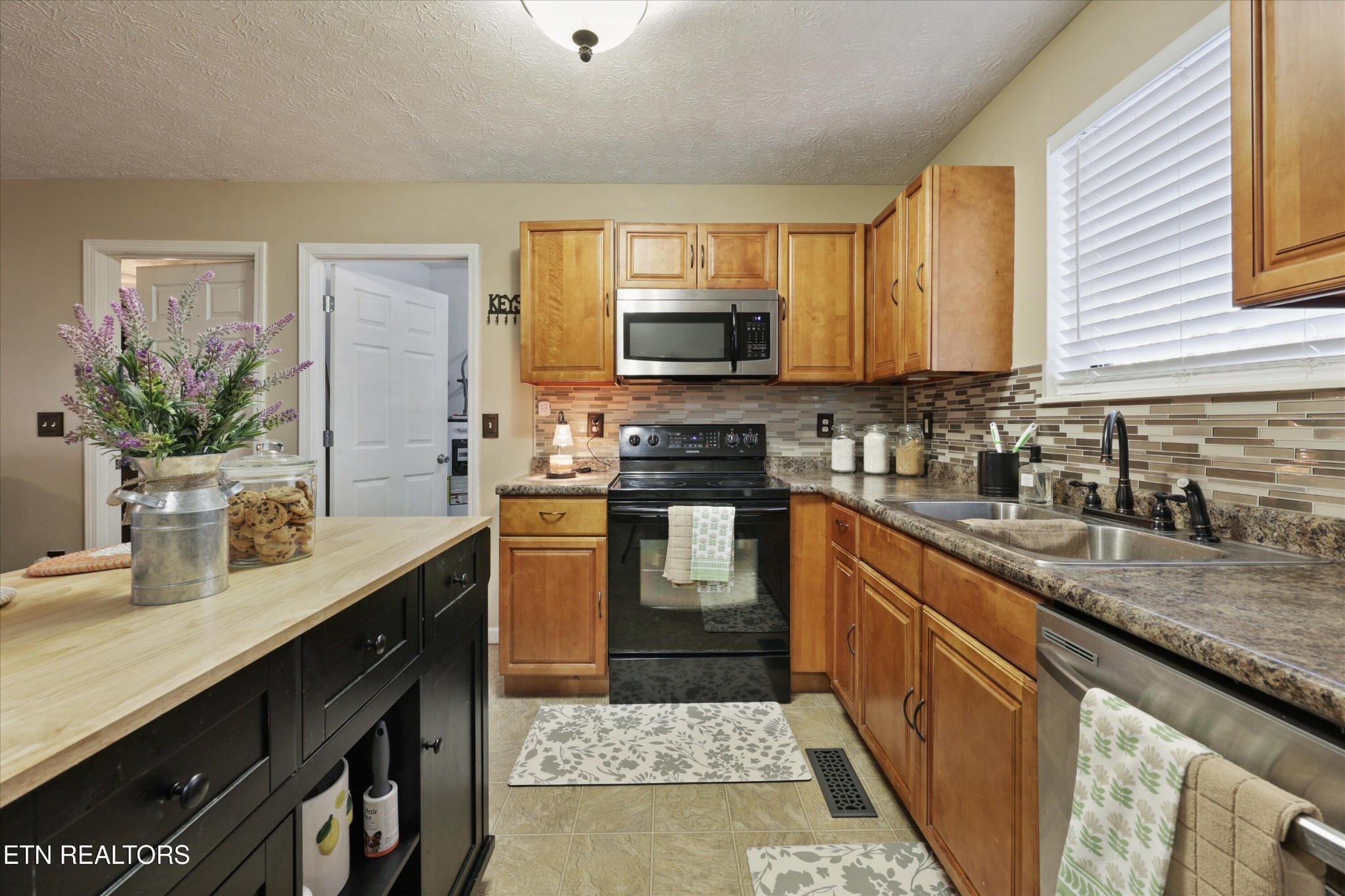 1306 Tabitha Drive White Pine, TN 37890 - Photo 10 of 31 a kitchen with stainless steel appliances granite countertop a sink stove and cabinets