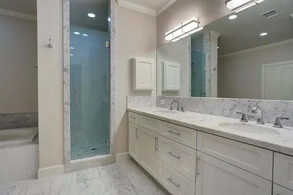 a bathroom with a double vanity sink and a mirror