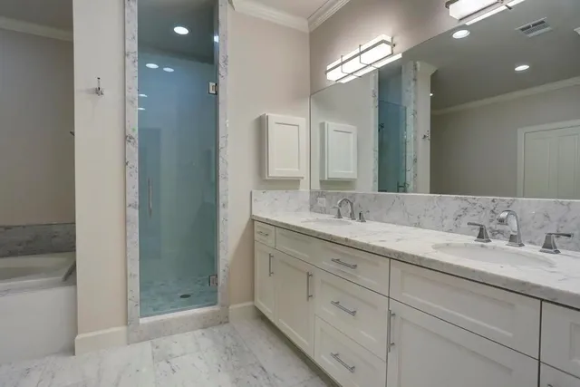 a bathroom with a double vanity sink and a mirror