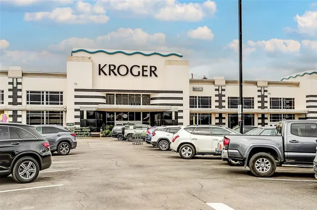 a view of a cars park in front of a building