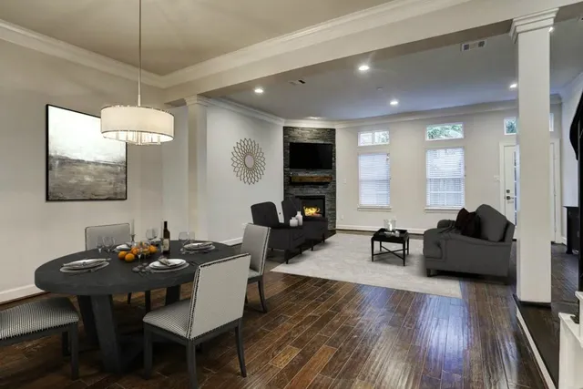 a living room with furniture flat screen tv and window