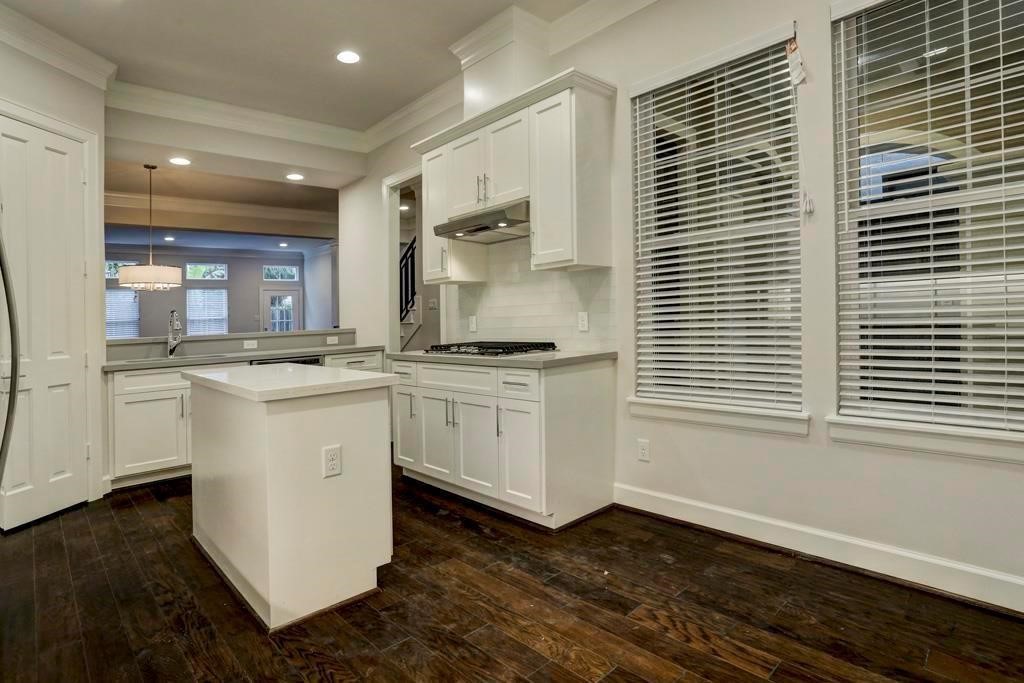 1522 Dunlavy Street, Unit B Houston, TX 77006 - Photo 4 of 16 a kitchen with white cabinets and white appliances