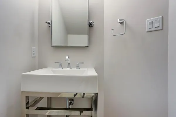 a bathroom with a sink a mirror and vanity