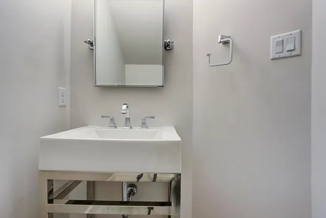 a bathroom with a sink a mirror and vanity