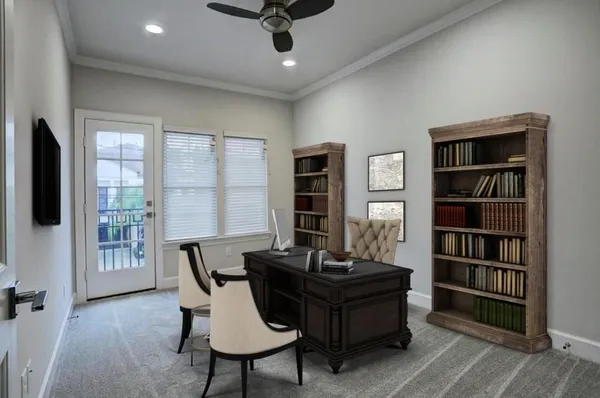 a view of a workspace with furniture and a window