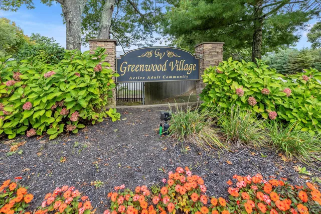 a sign that is sitting in the middle of plants