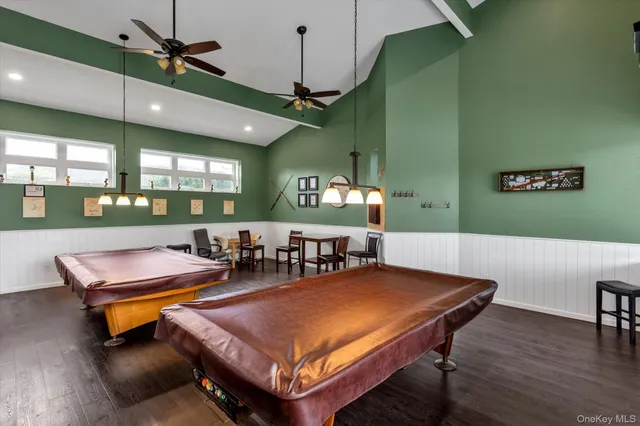 a living room with furniture pool table and chandelier
