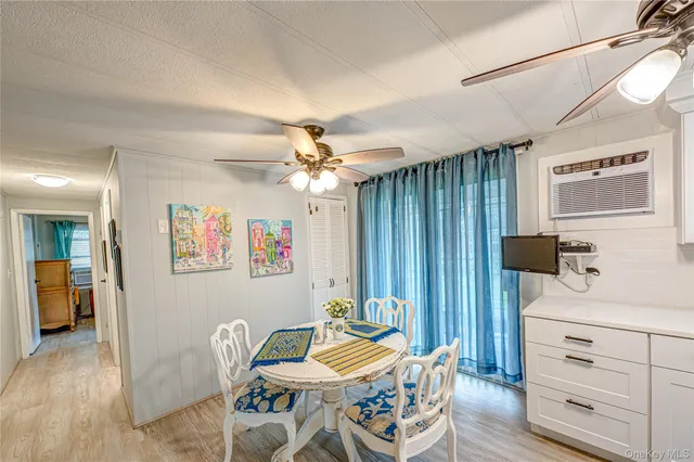 a bedroom with furniture and a chandelier fan