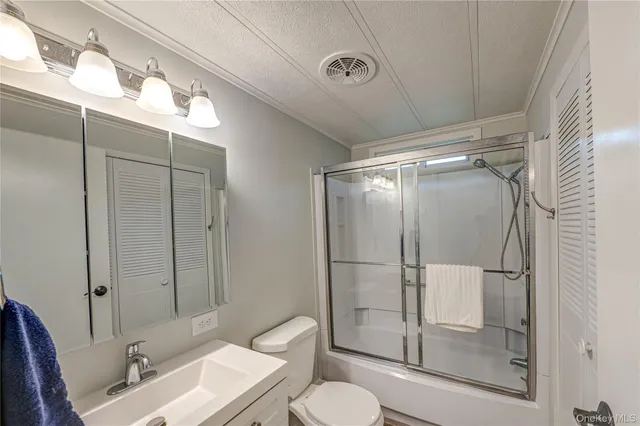 a bathroom with a toilet a sink and shower