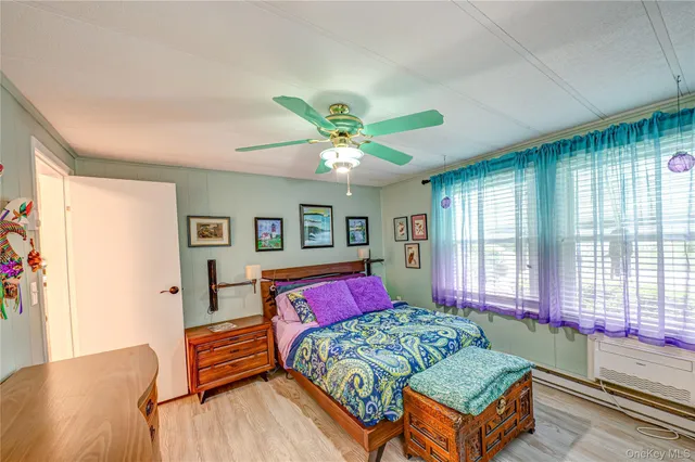 a bedroom with a bed and a large window