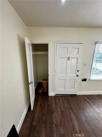 an entryway with wooden floor and window