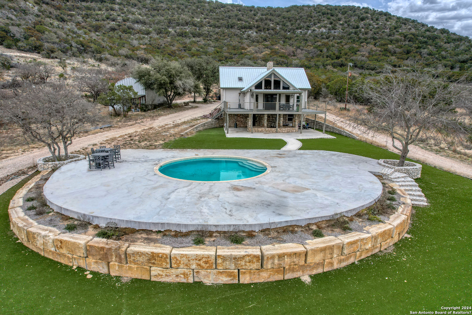 an aerial view of a house with outdoor space