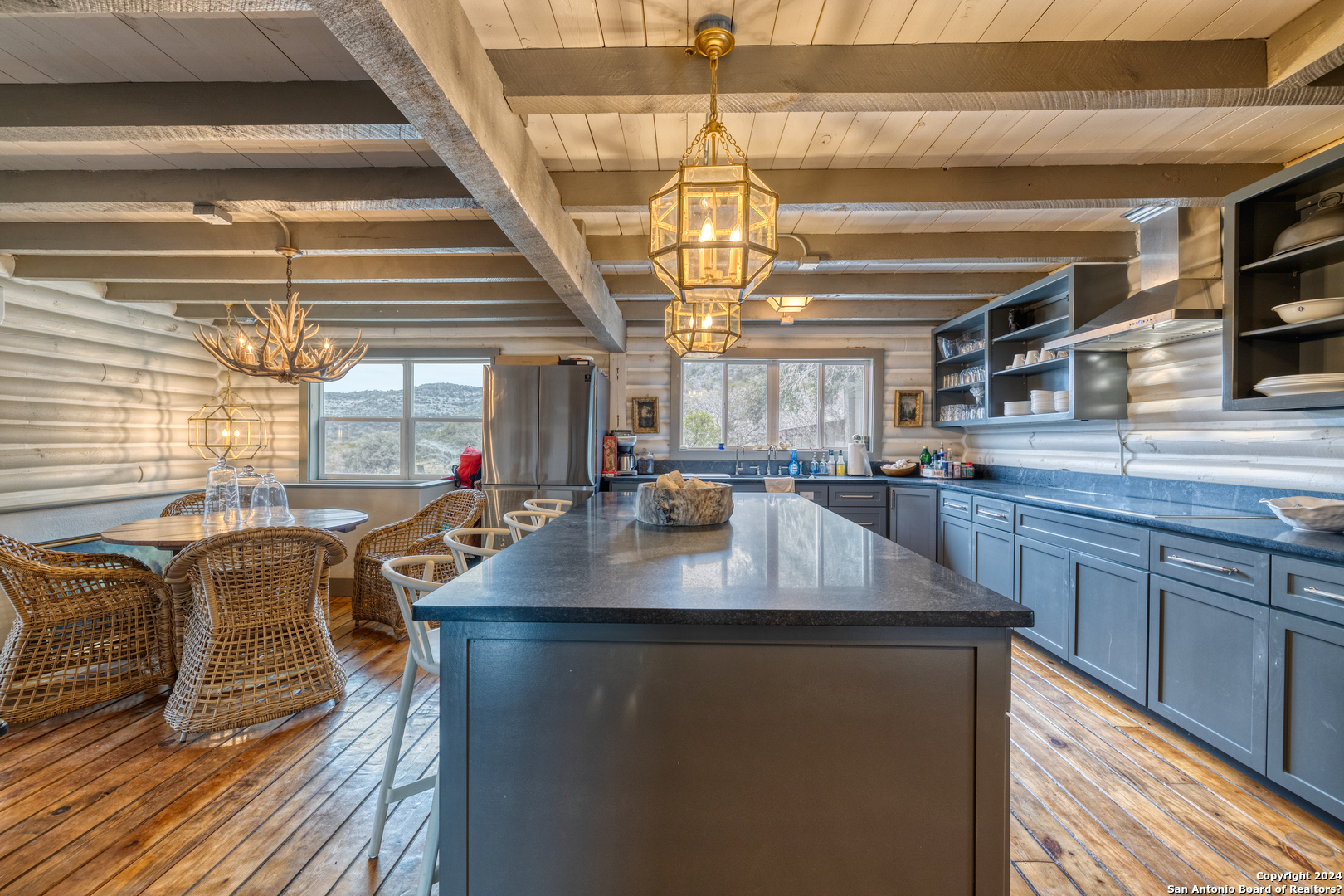 254 North Fork Bonner Road Leakey, TX 78873 - Photo 11 of 47 a dining table with chairs and kitchen view
