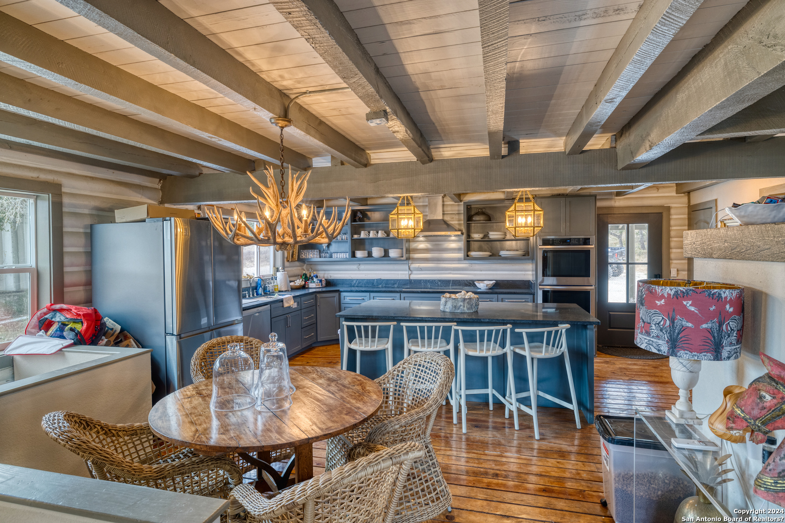 254 North Fork Bonner Road Leakey, TX 78873 - Photo 12 of 47 a dining room with furniture a rug and wooden floor