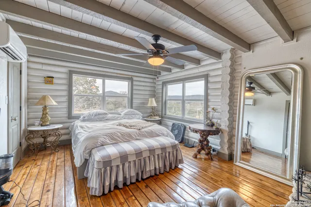 a spacious bedroom with a bed and glass door