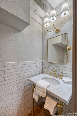 a bathroom with a granite countertop sink a mirror and vanity