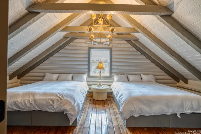 a bed sitting in a bedroom next to a larger window