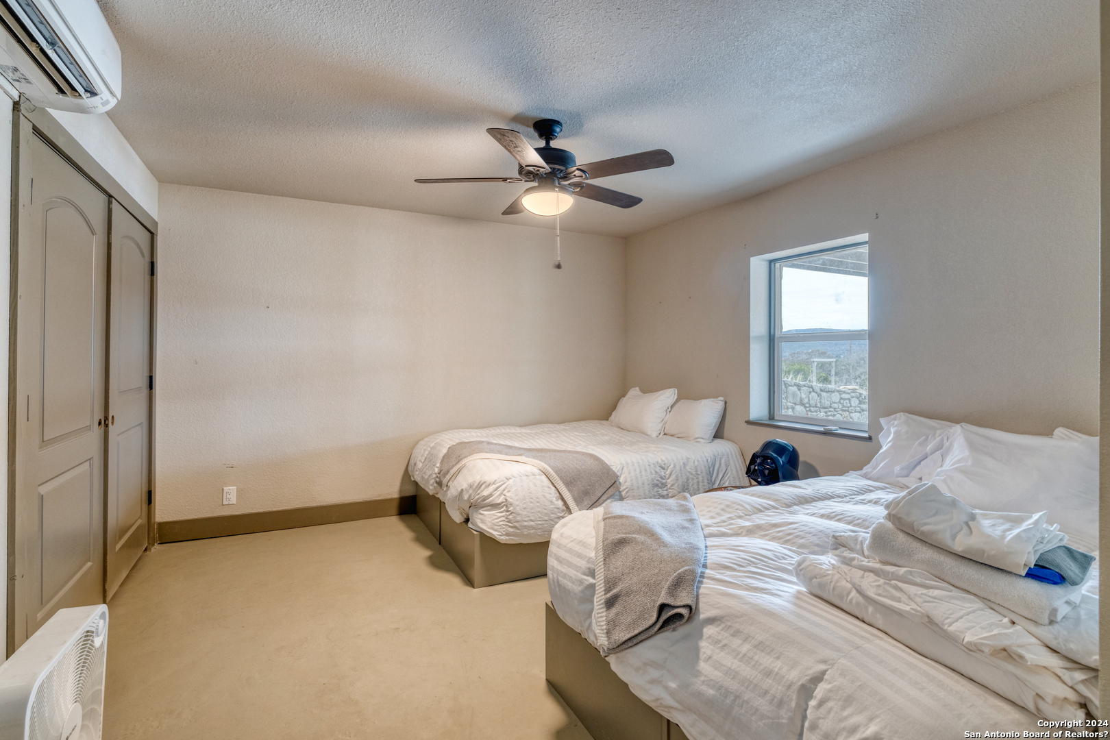 254 North Fork Bonner Road Leakey, TX 78873 - Photo 25 of 47 a bedroom with two beds and a ceiling fan