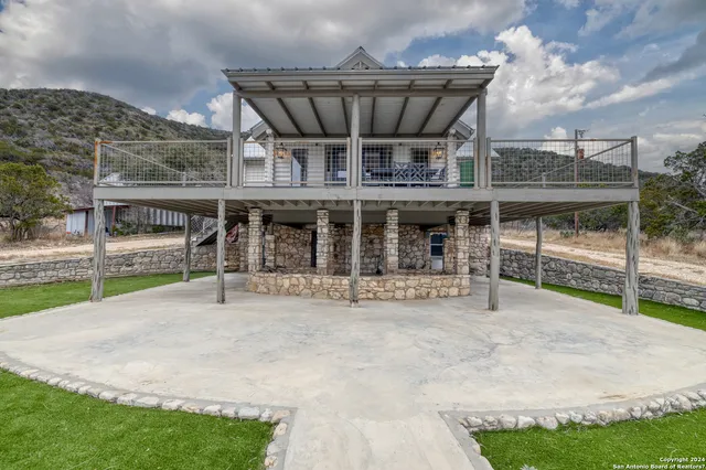 a view of a house with a porch and a yard
