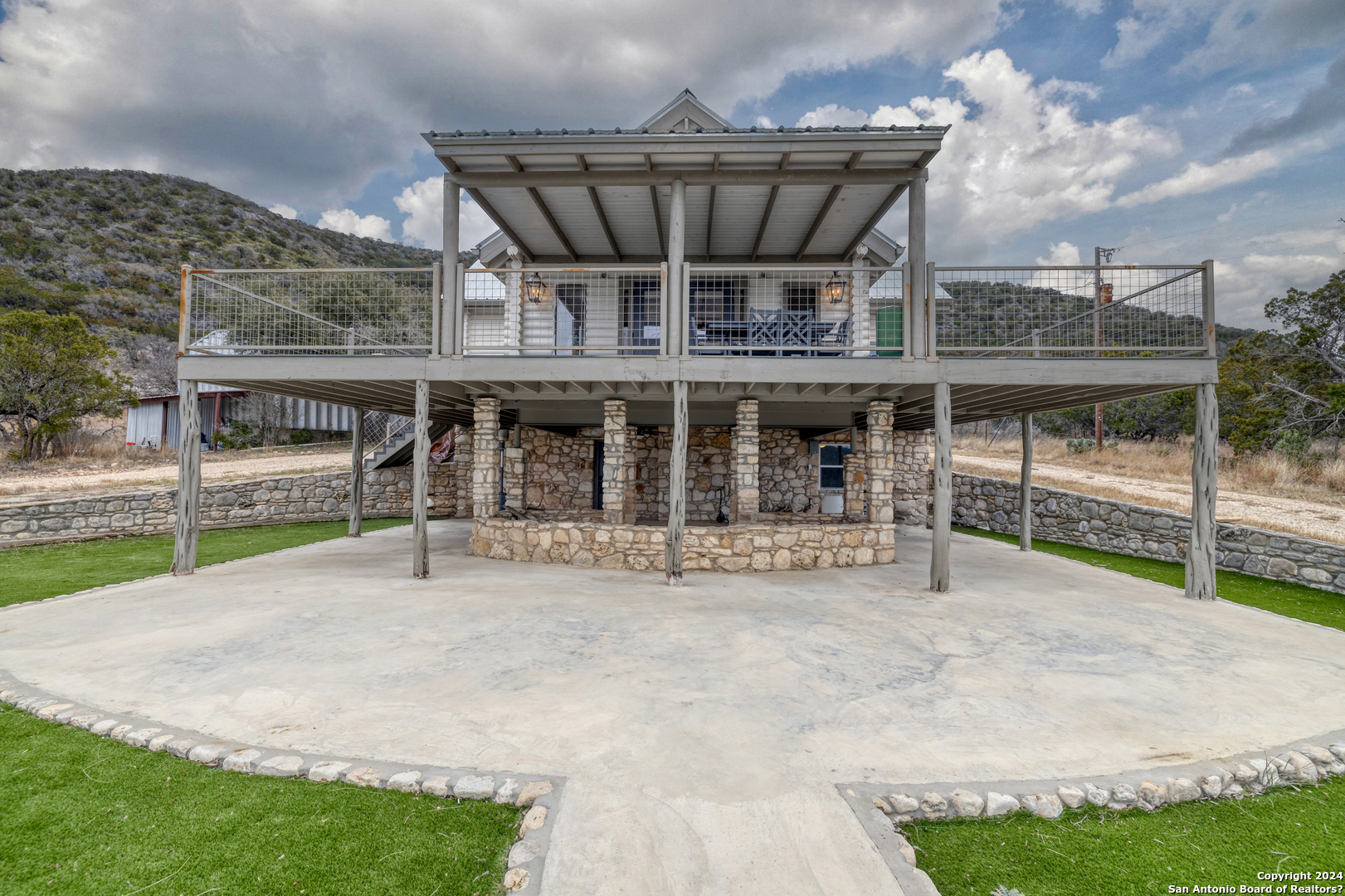 254 North Fork Bonner Road Leakey, TX 78873 - Photo 29 of 47 a view of a house with a porch and a yard
