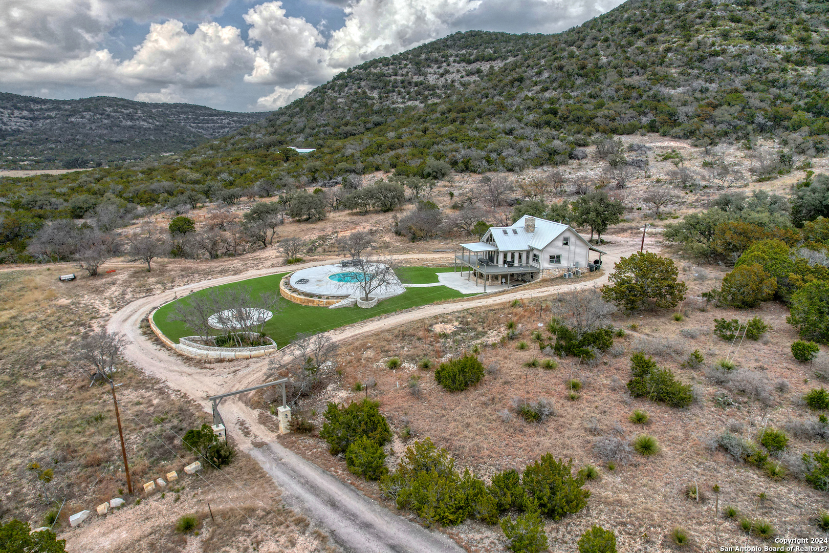 254 North Fork Bonner Road Leakey, TX 78873 - Photo 3 of 47 a view of a small pool with lawn chairs and a table