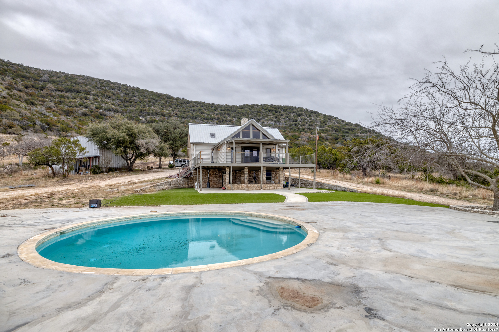 254 North Fork Bonner Road Leakey, TX 78873 - Photo 31 of 47 a view of a swimming pool with a yard and large trees