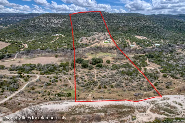 a view of a yard with wooden fence