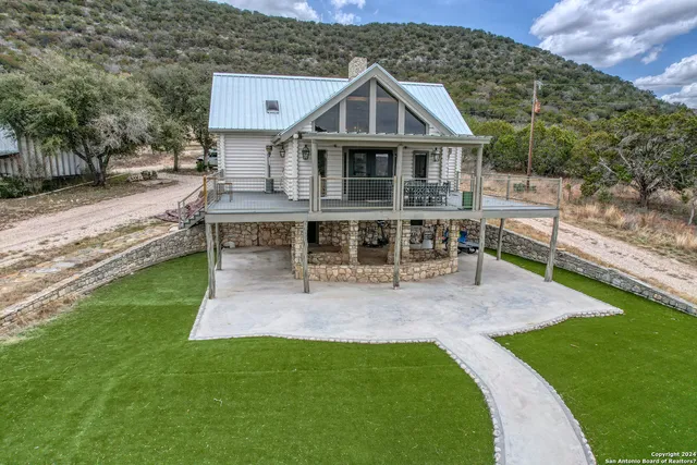 an aerial view of a house with sitting area and garden