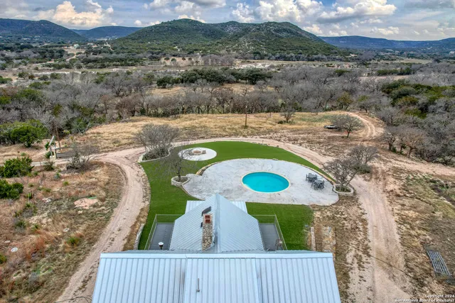 a view of a balcony with furniture and a garden
