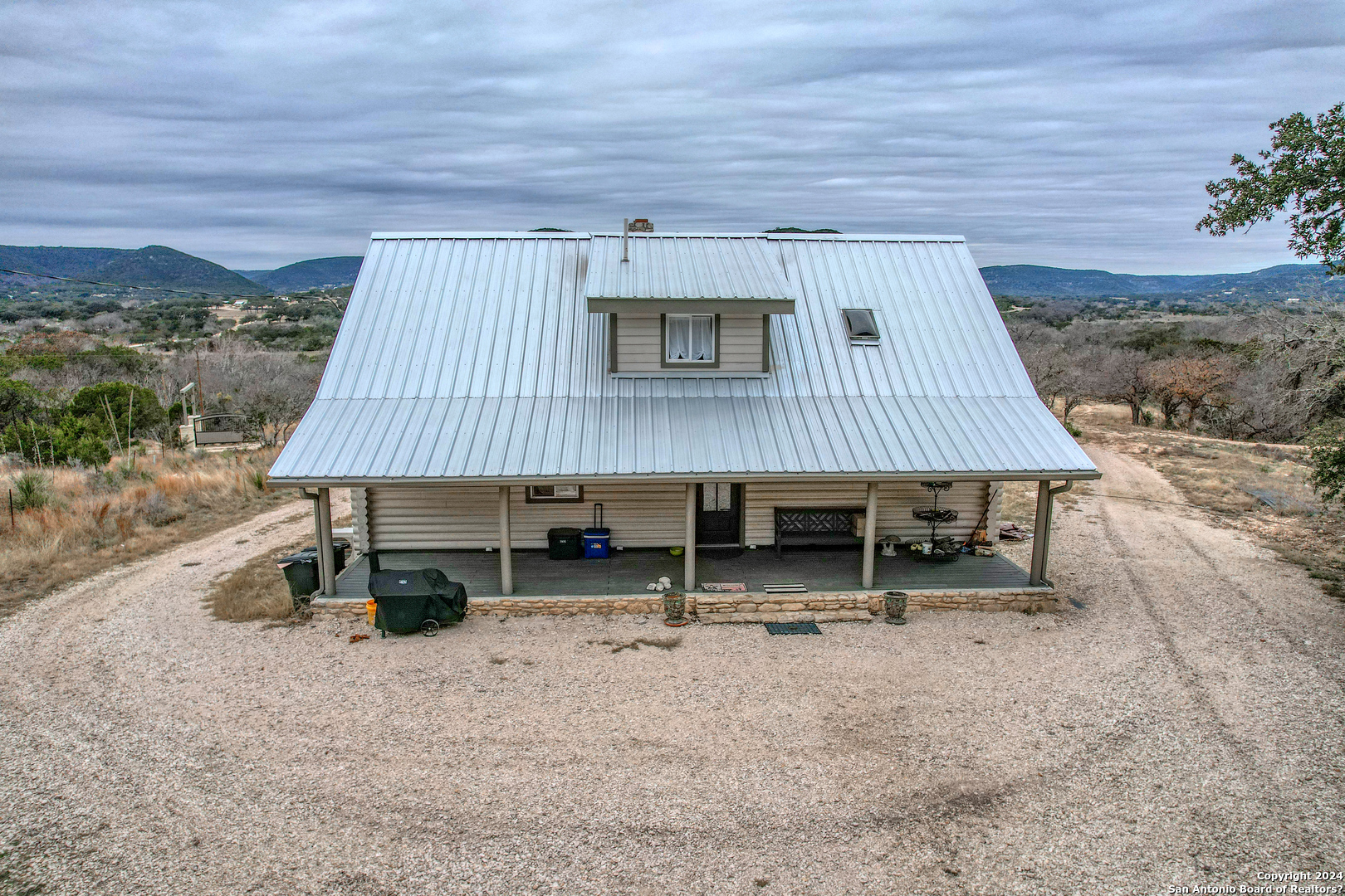 254 North Fork Bonner Road Leakey, TX 78873 - Photo 8 of 47 a backyard of a house with barbeque oven table and chairs
