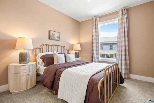 a bedroom with a bed and a night stand