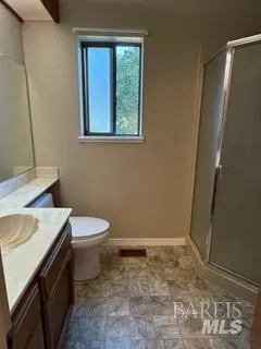 a bathroom with a sink a toilet and a window