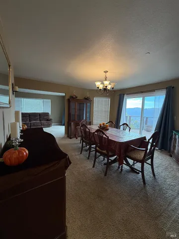 a living room with furniture a chandelier a rug and a window