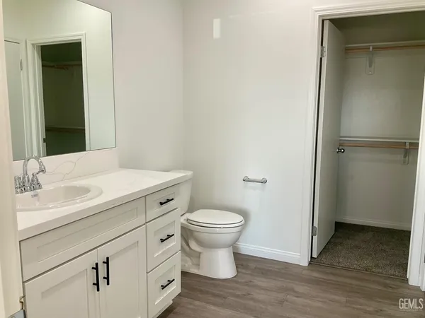 a bathroom with a sink toilet and a mirror