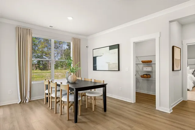 a living room with dining room and wooden floor