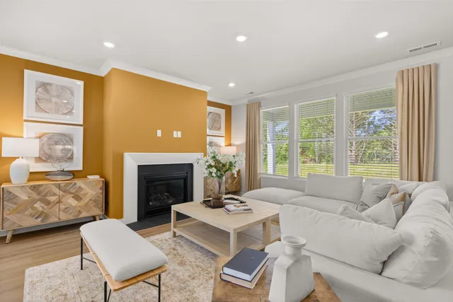 a living room with furniture and large windows