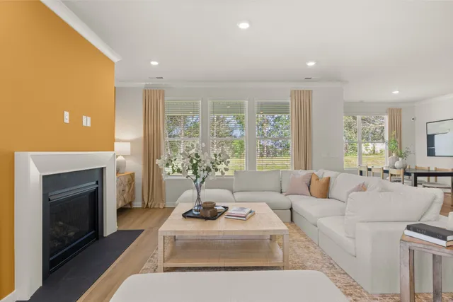 a living room with furniture a large window and a table