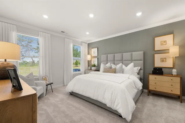 a large bed sitting in a bedroom next to a window