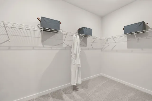 a bedroom with a bed and painting on the wall