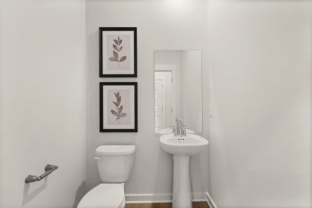 a view of a hallway with wooden floor and closet