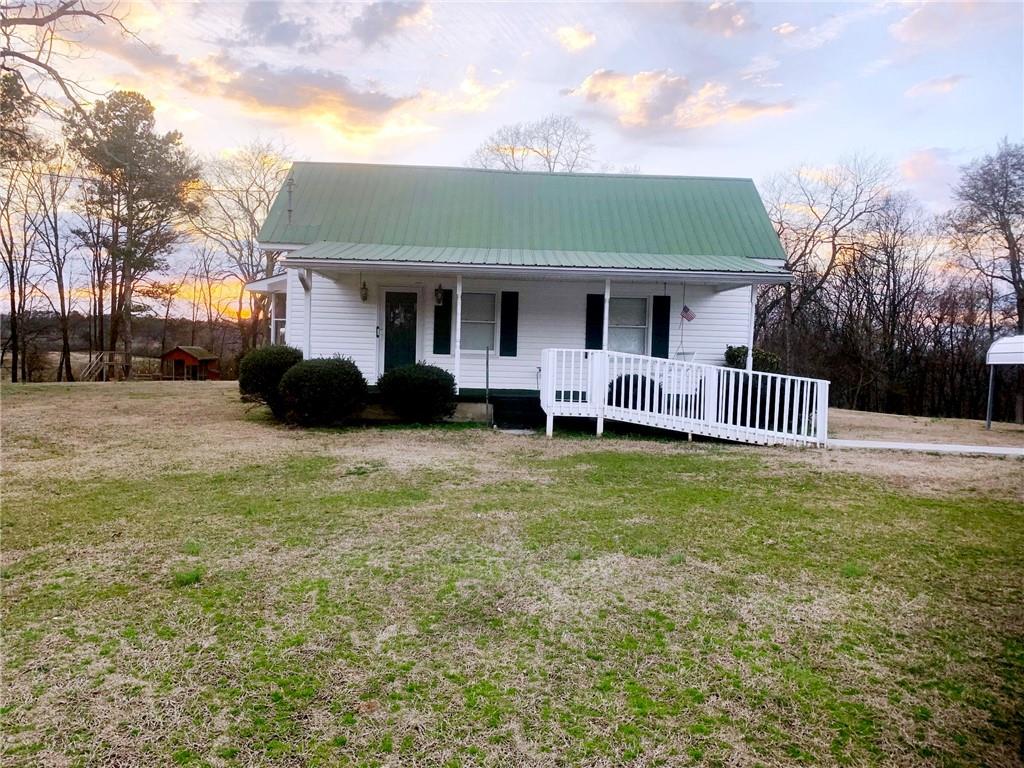 420 Walraven Road Northeast Calhoun, GA 30701 - Photo 1 of 1 a front view of a house with a garden