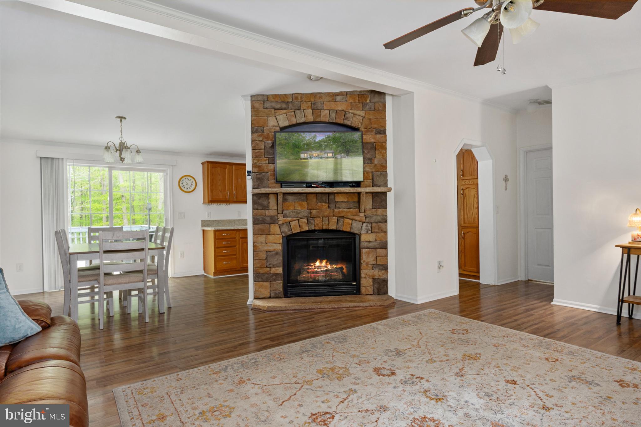 2319 Sizer Road Beaverdam, VA 23015 - Photo 17 of 61 a living room with furniture a fireplace and a flat screen tv