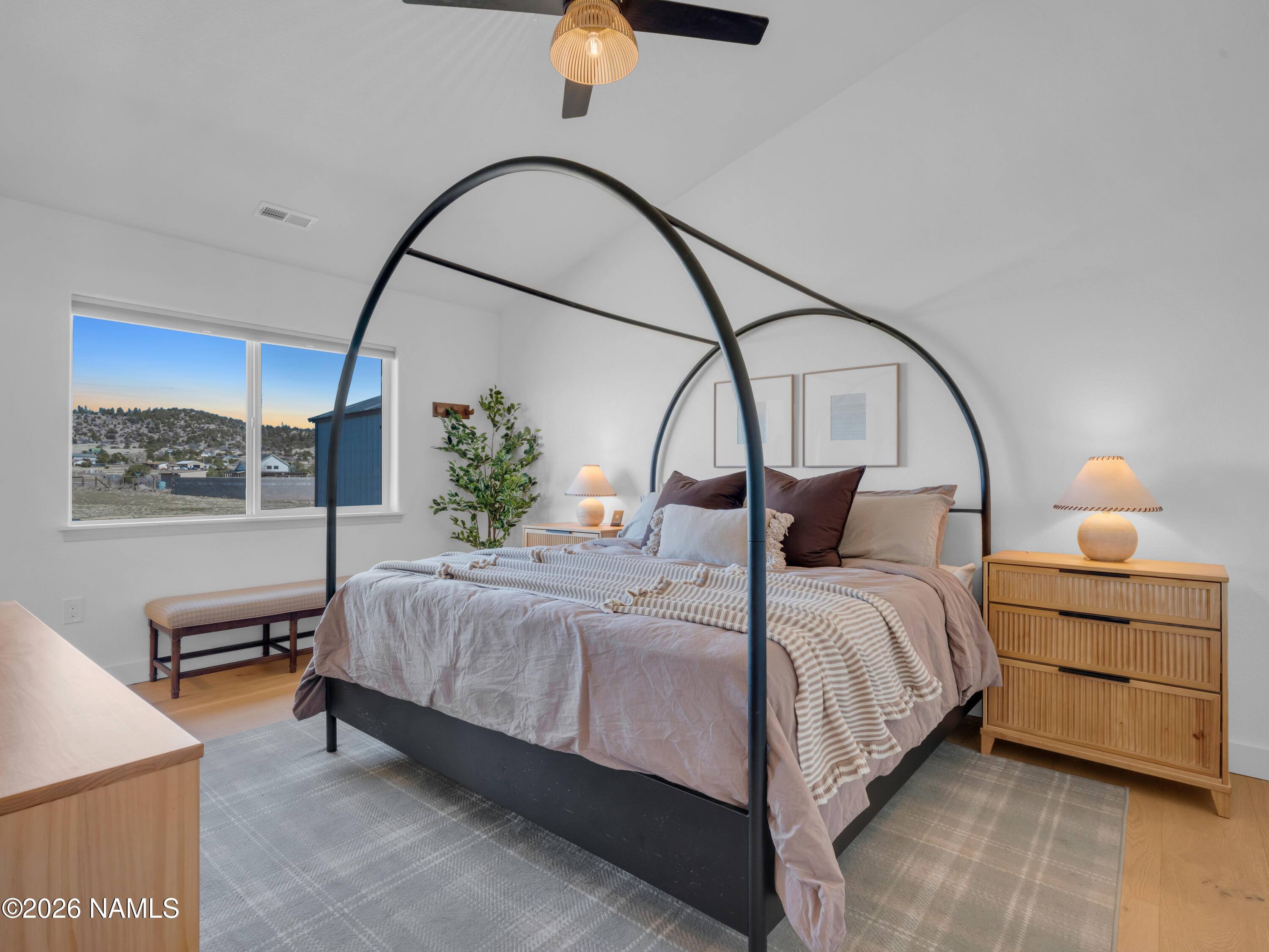 8115 Fawn Run Road Flagstaff, AZ 86004 - Photo 13 of 26 a bedroom with a bed a chandelier and a window