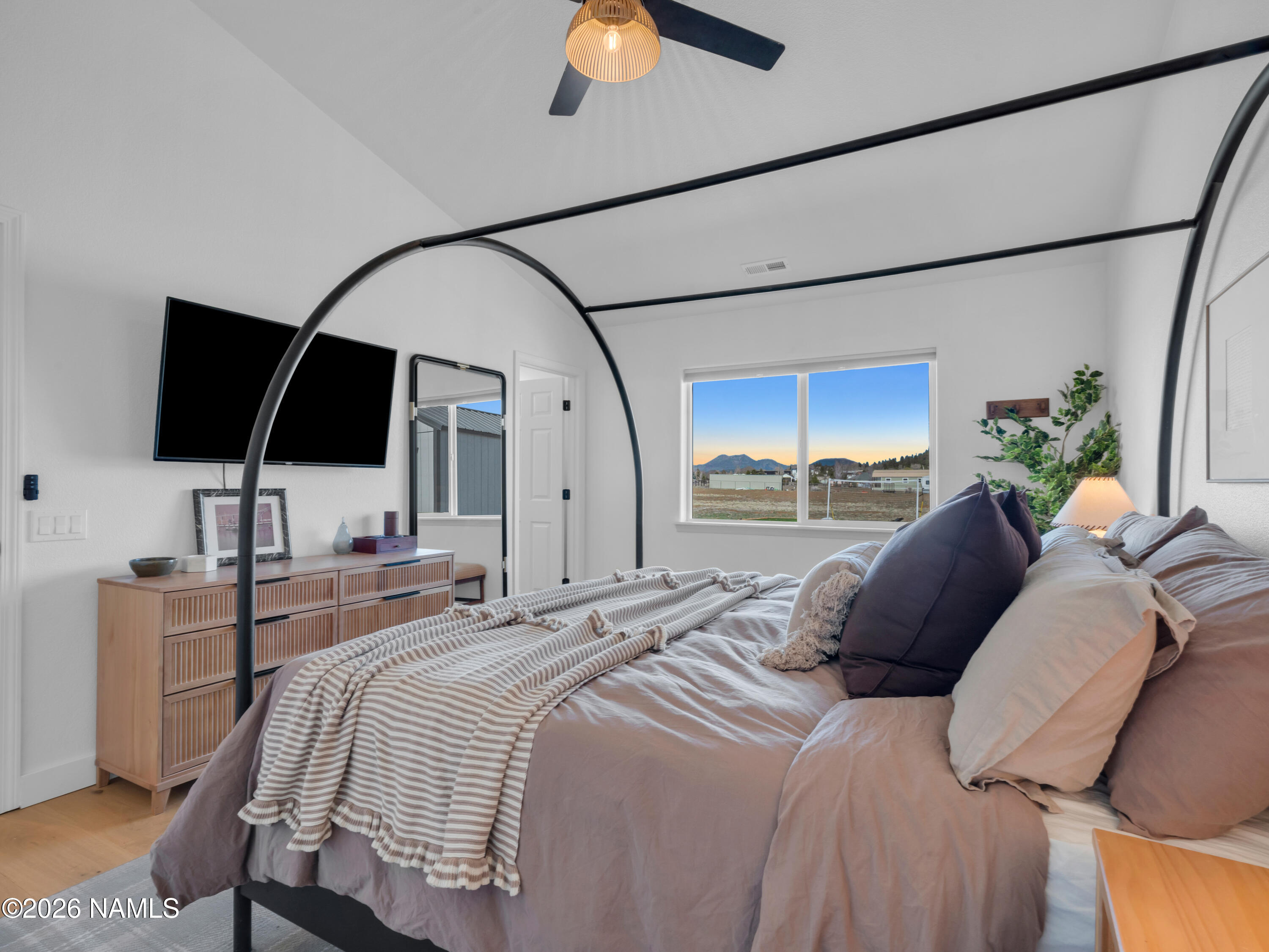 8115 Fawn Run Road Flagstaff, AZ 86004 - Photo 14 of 26 a bedroom with a bed and a flat tv screen