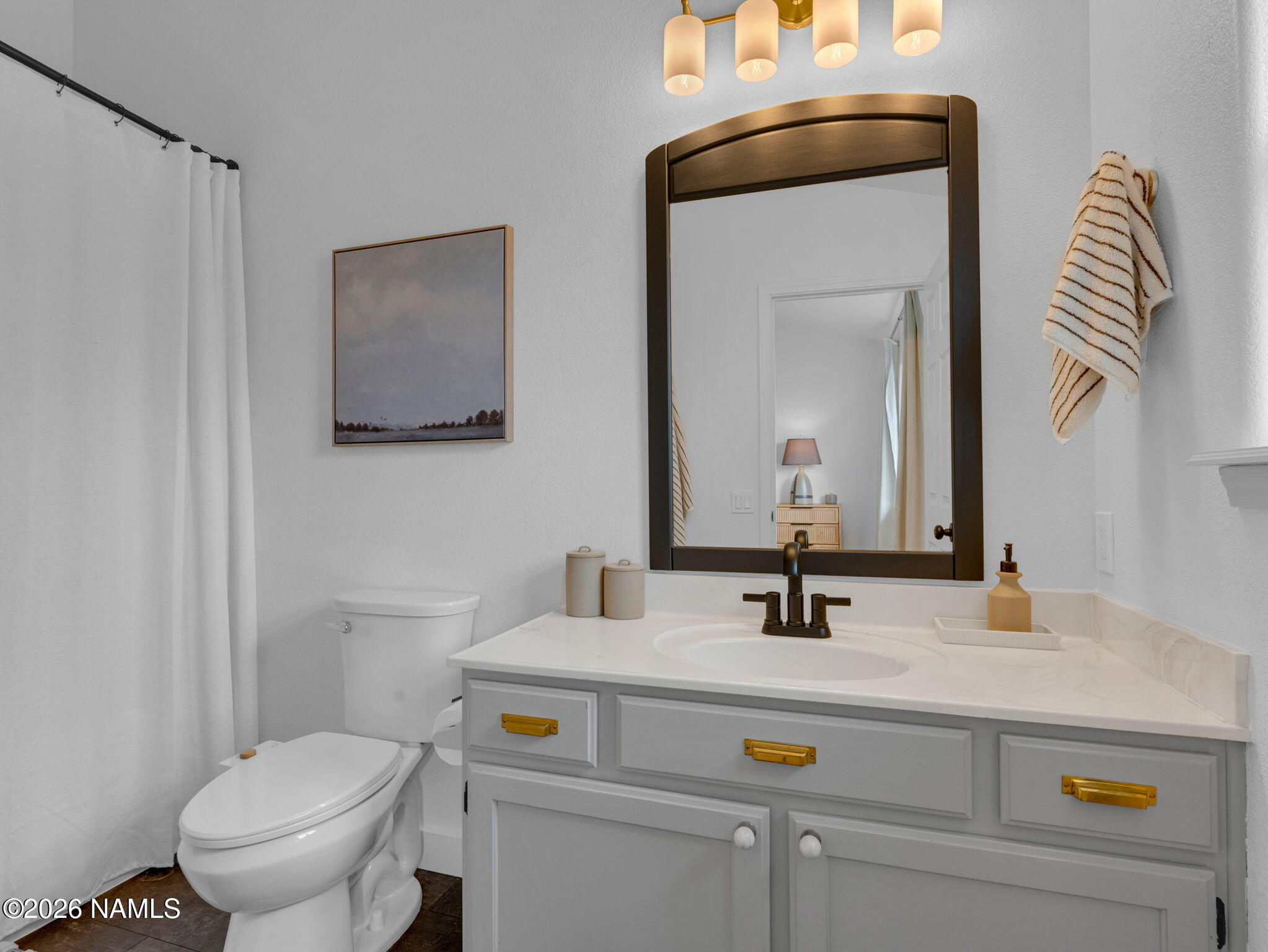 8115 Fawn Run Road Flagstaff, AZ 86004 - Photo 15 of 26 a bathroom with a sink a toilet and mirror