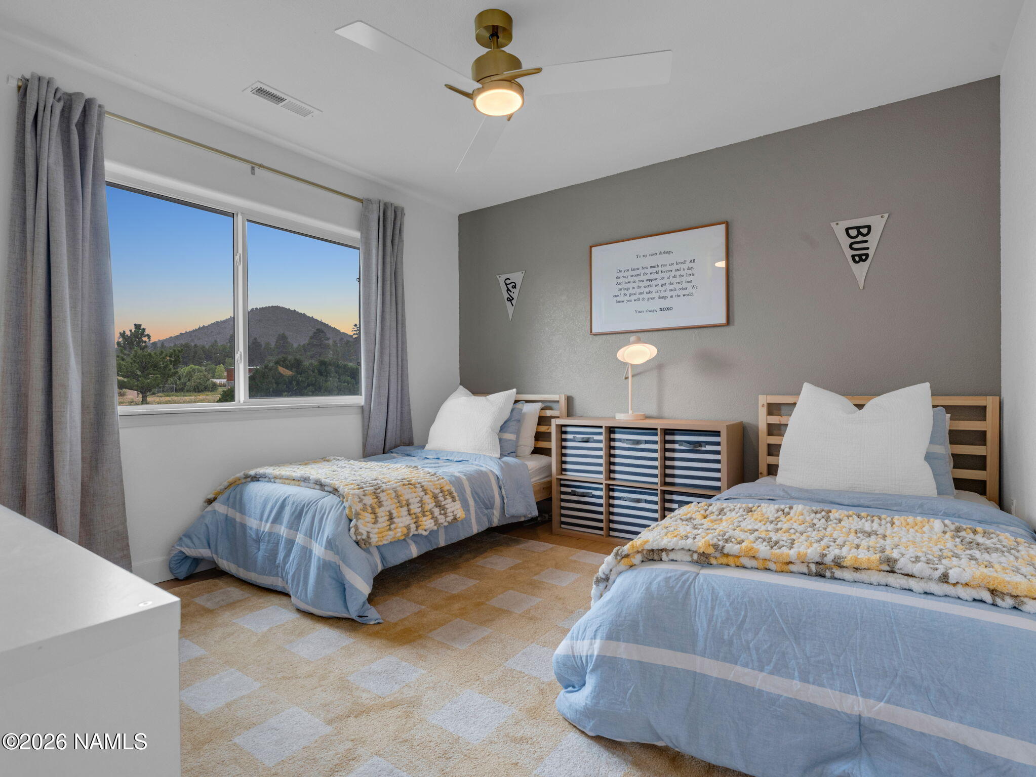8115 Fawn Run Road Flagstaff, AZ 86004 - Photo 16 of 26 a bedroom with a bed lamp and a large window